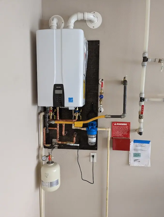 Professional plumber installing copper piping in a Cabot home